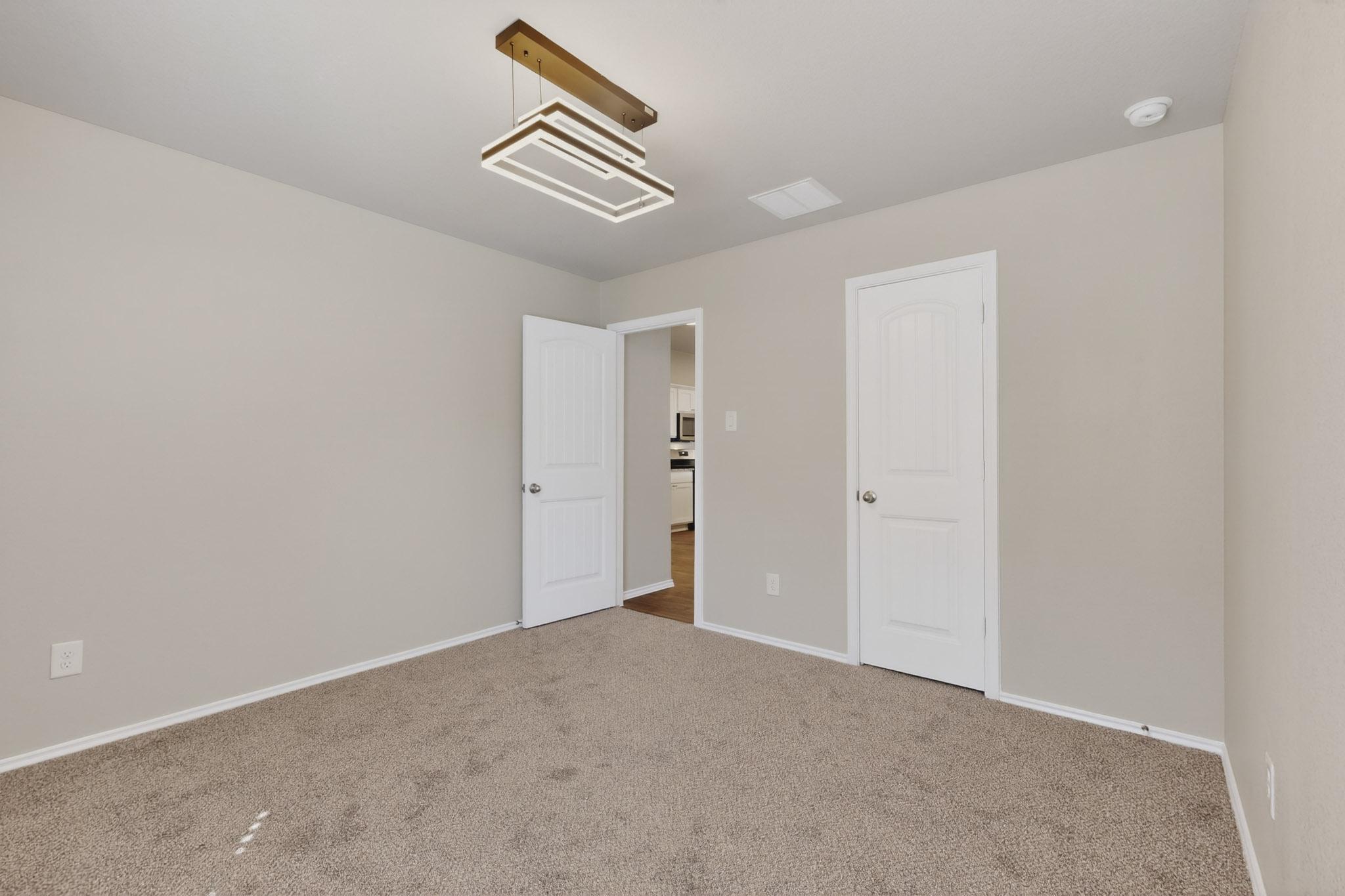 218 Sickle Loop Kyle, TX 78640 - Photo 20 of 34 Unfurnished bedroom featuring carpet floors and baseboards