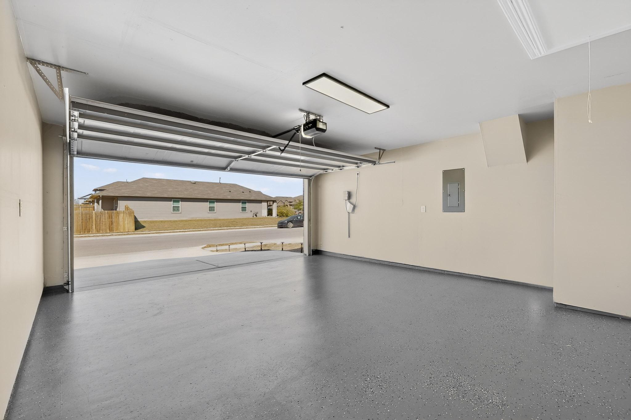218 Sickle Loop Kyle, TX 78640 - Photo 29 of 34 Garage with electric panel, a residential view, and a garage door opener