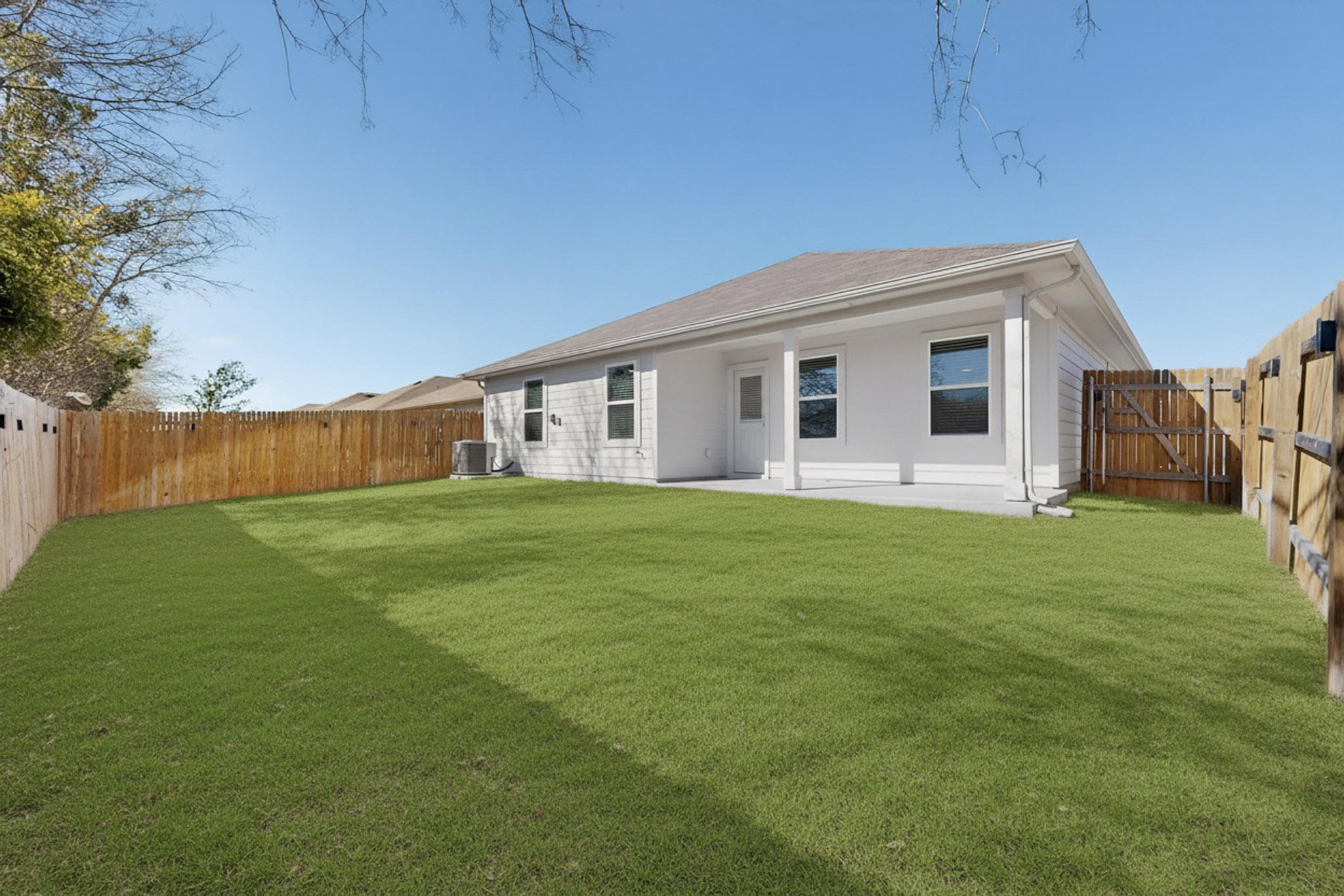 218 Sickle Loop Kyle, TX 78640 - Photo 31 of 34 Rear view of house featuring a fenced backyard and a patio area