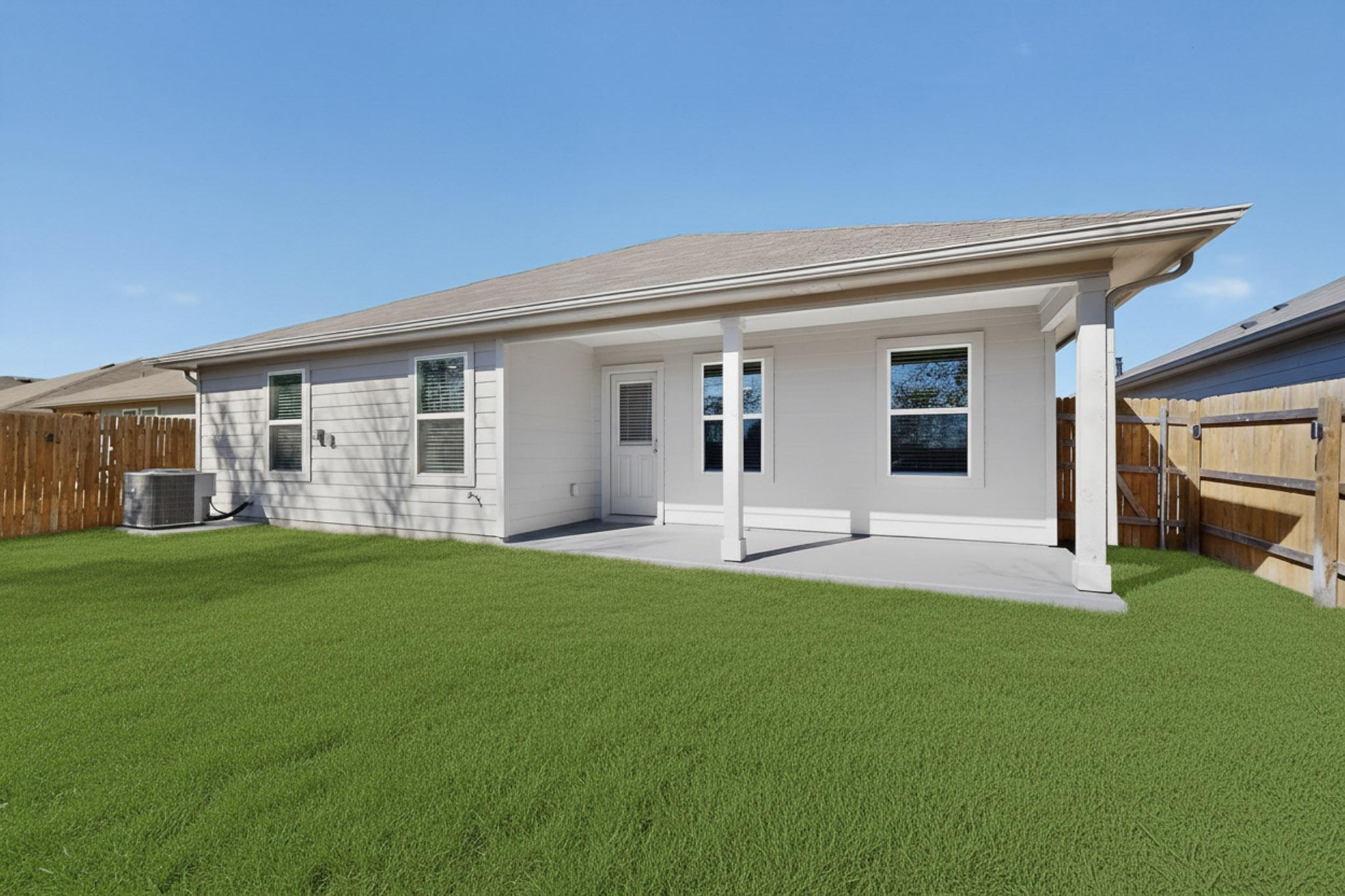 218 Sickle Loop Kyle, TX 78640 - Photo 32 of 34 Back of house with a patio area and a fenced backyard