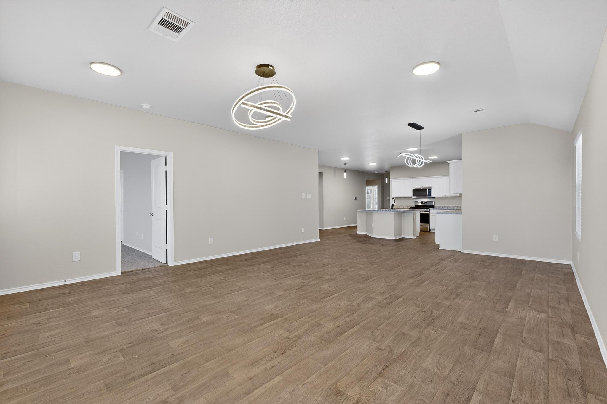 218 Sickle Loop Kyle, TX 78640 - Photo 6 of 34 Unfurnished living room with light wood-type flooring and recessed lighting