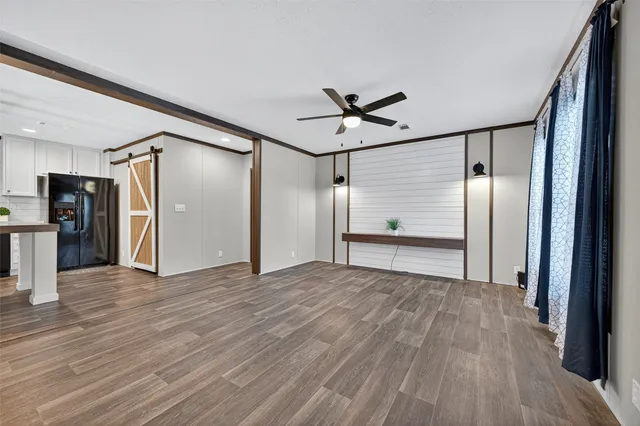 a view of empty room with wooden floor
