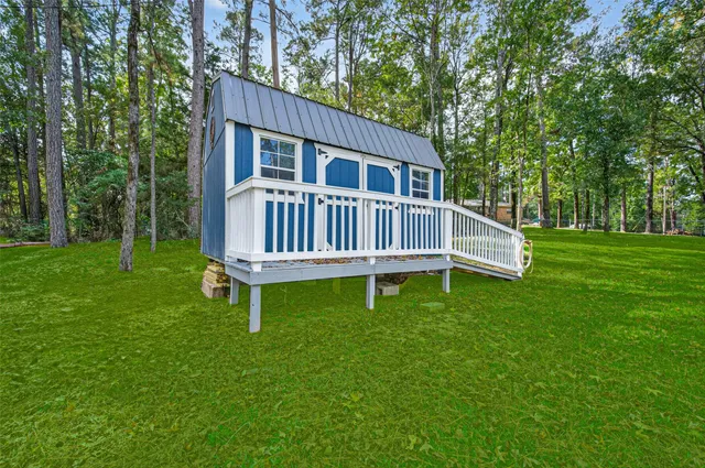 a view of a house with a yard and deck