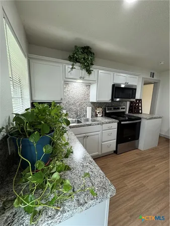 a table with chairs and wooden floor