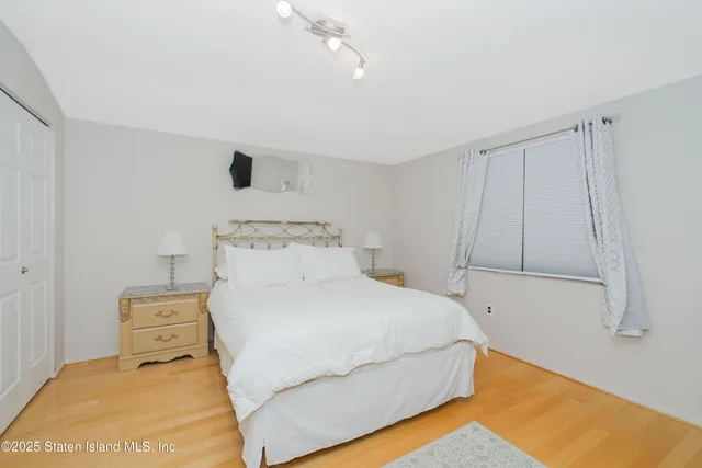 a bedroom with a bed and a night stand