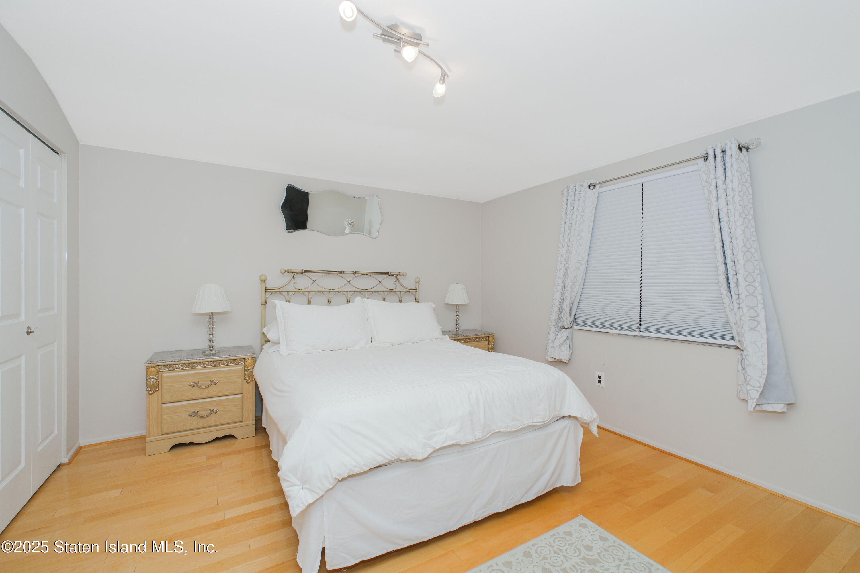 149 Crossfield Avenue Staten Island, NY 10312 - Photo 16 of 23 a bedroom with a bed and a night stand