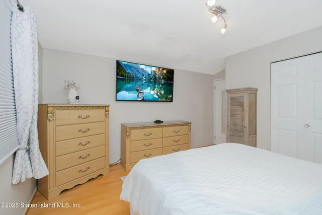 a bedroom with a bed and a dresser