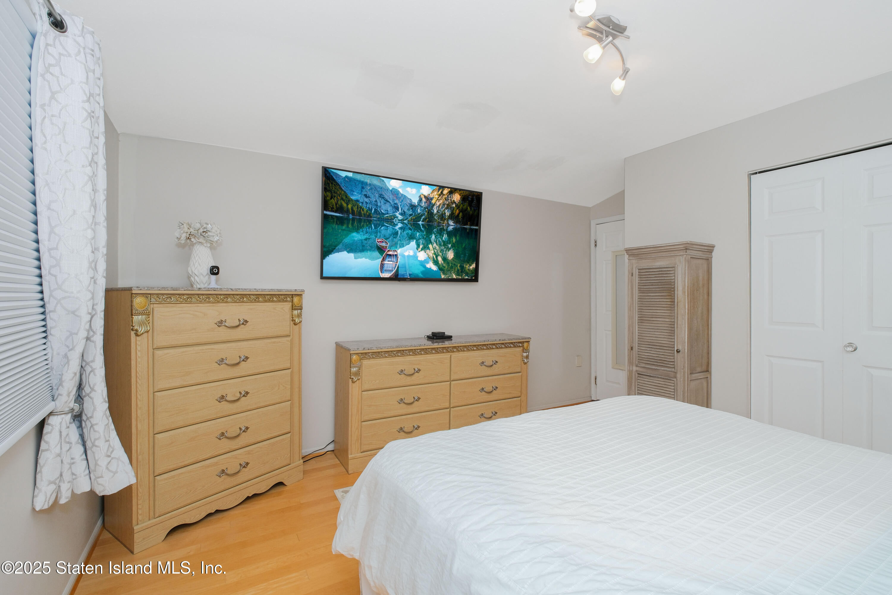 149 Crossfield Avenue Staten Island, NY 10312 - Photo 17 of 23 a bedroom with a bed and a dresser