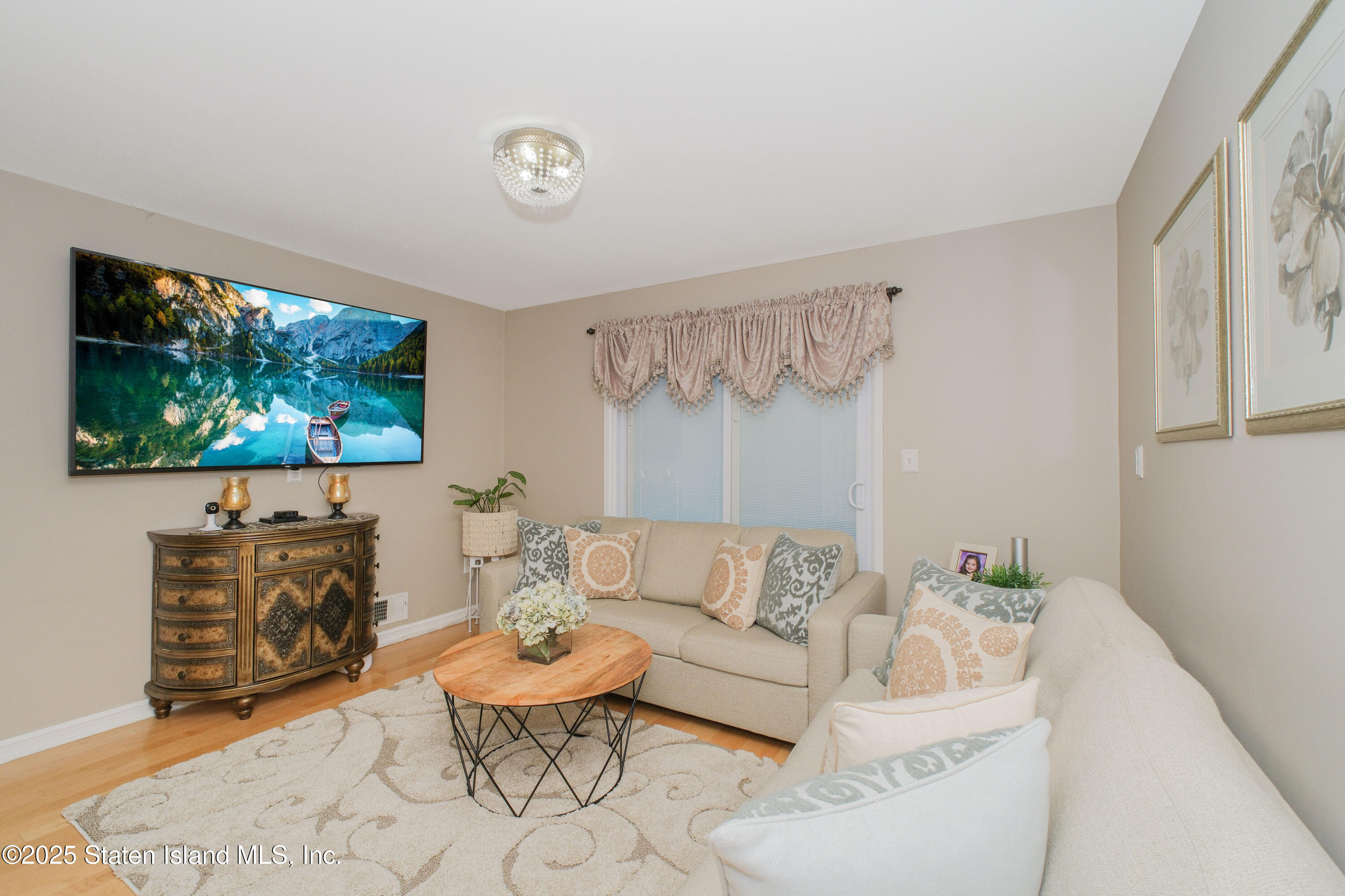 149 Crossfield Avenue Staten Island, NY 10312 - Photo 5 of 23 a living room with furniture a flat screen tv and a large window