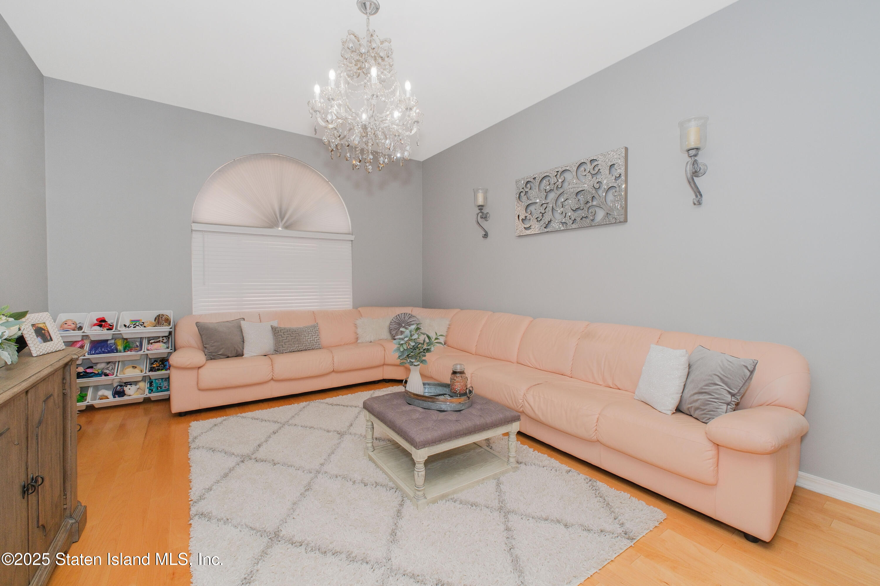 149 Crossfield Avenue Staten Island, NY 10312 - Photo 10 of 23 a living room with furniture and a chandelier