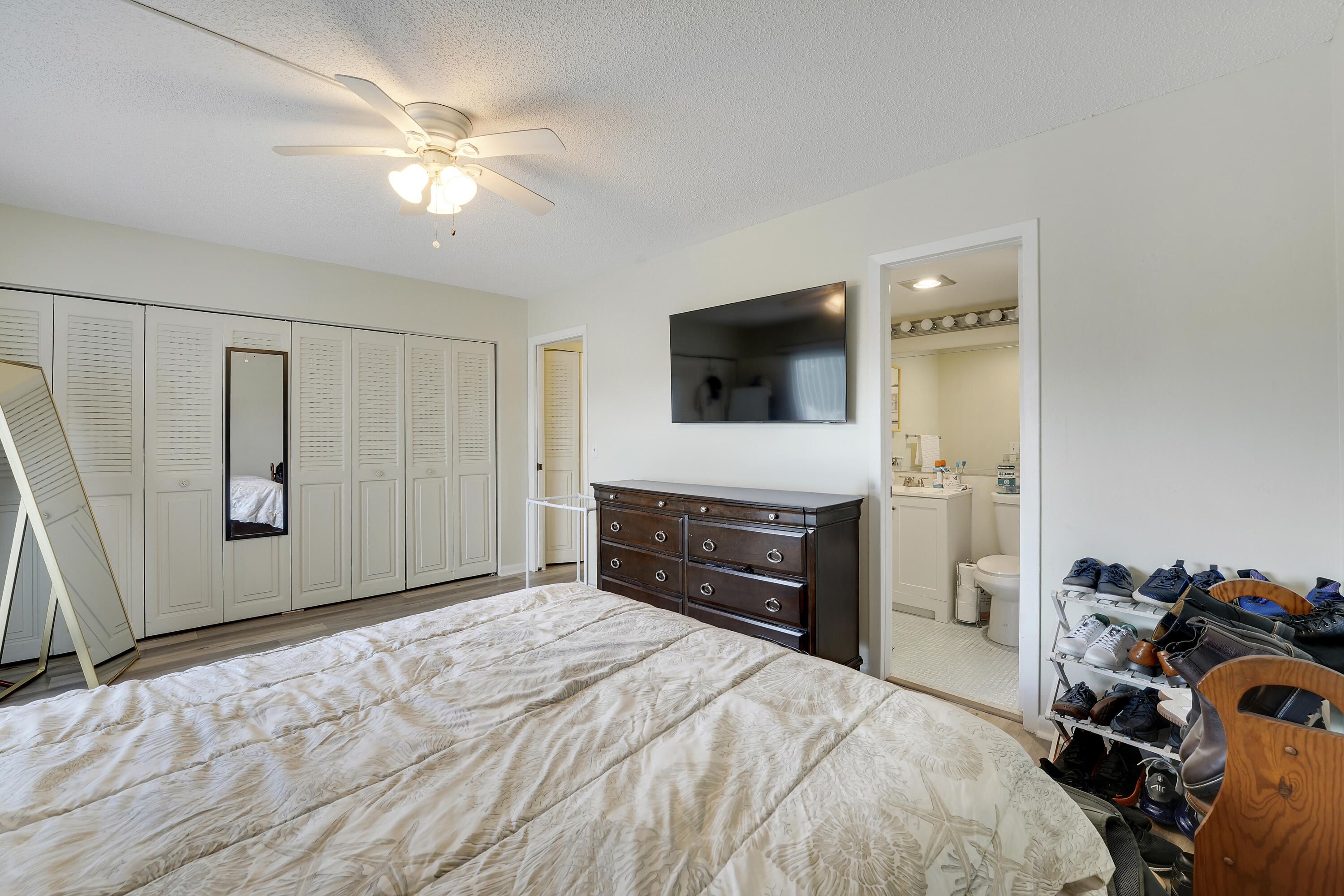 146 Mansfield D Boca Raton, FL 33434 - Photo 10 of 12 a bedroom with a bed and a flat screen tv