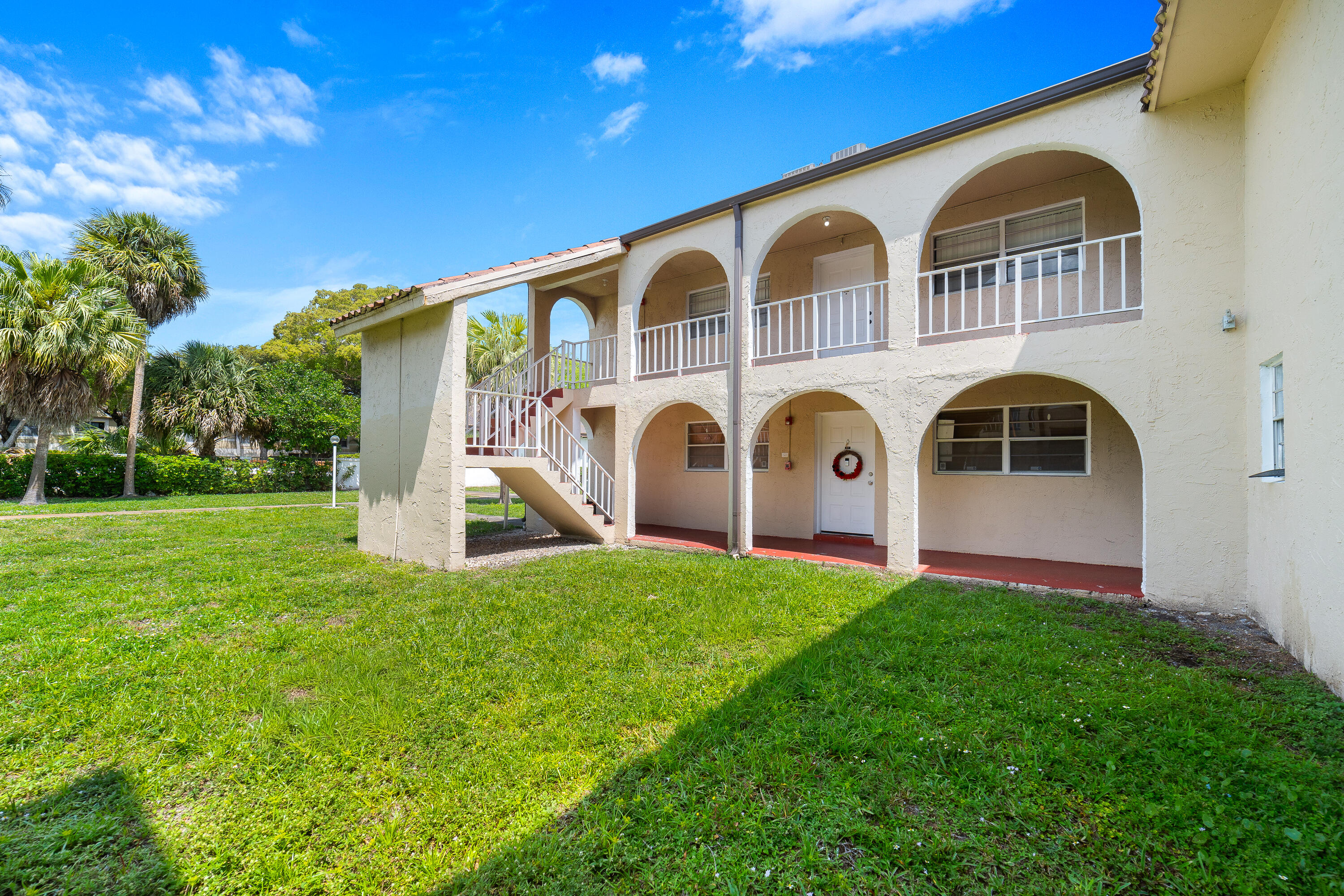 2710 Riverside Drive, Unit 201A Coral Springs, FL 33065 - Photo 1 of 23 a front view of a house with garden and porch