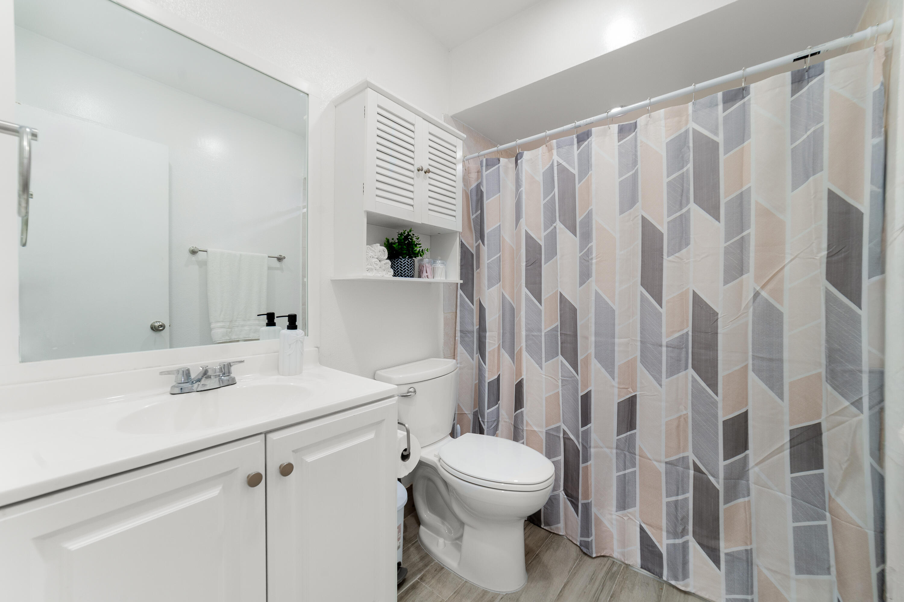 2710 Riverside Drive, Unit 201A Coral Springs, FL 33065 - Photo 13 of 23 a bathroom with a sink a toilet and shower