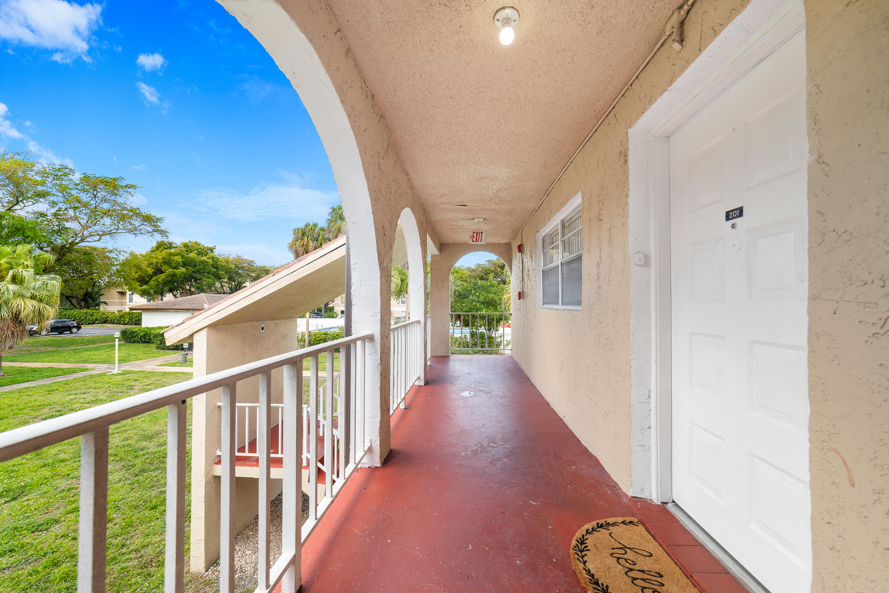 2710 Riverside Drive, Unit 201A Coral Springs, FL 33065 - Photo 2 of 23 a view of a porch with wooden floor and stairs