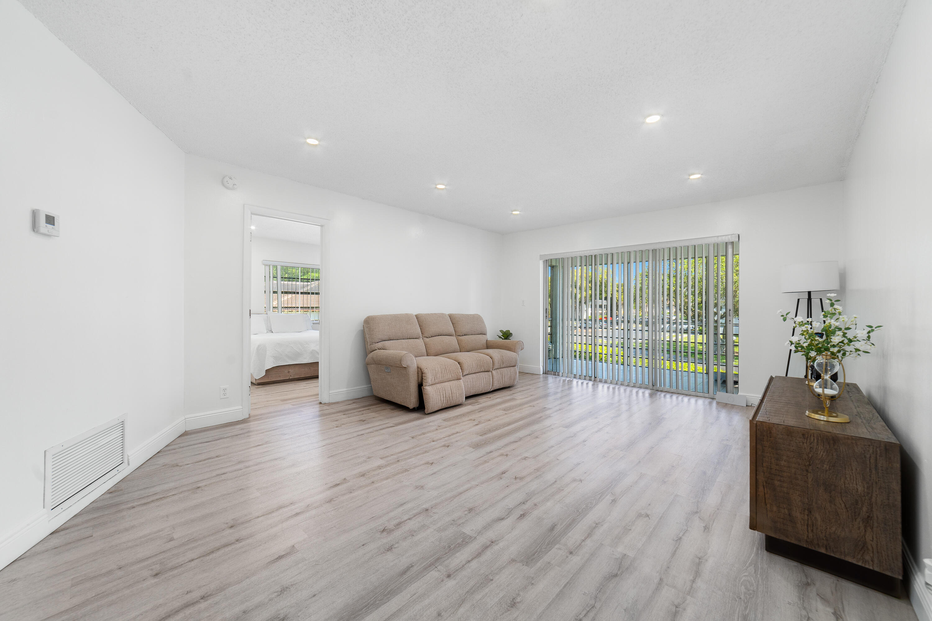 2710 Riverside Drive, Unit 201A Coral Springs, FL 33065 - Photo 3 of 23 a living room with furniture window and wooden floor