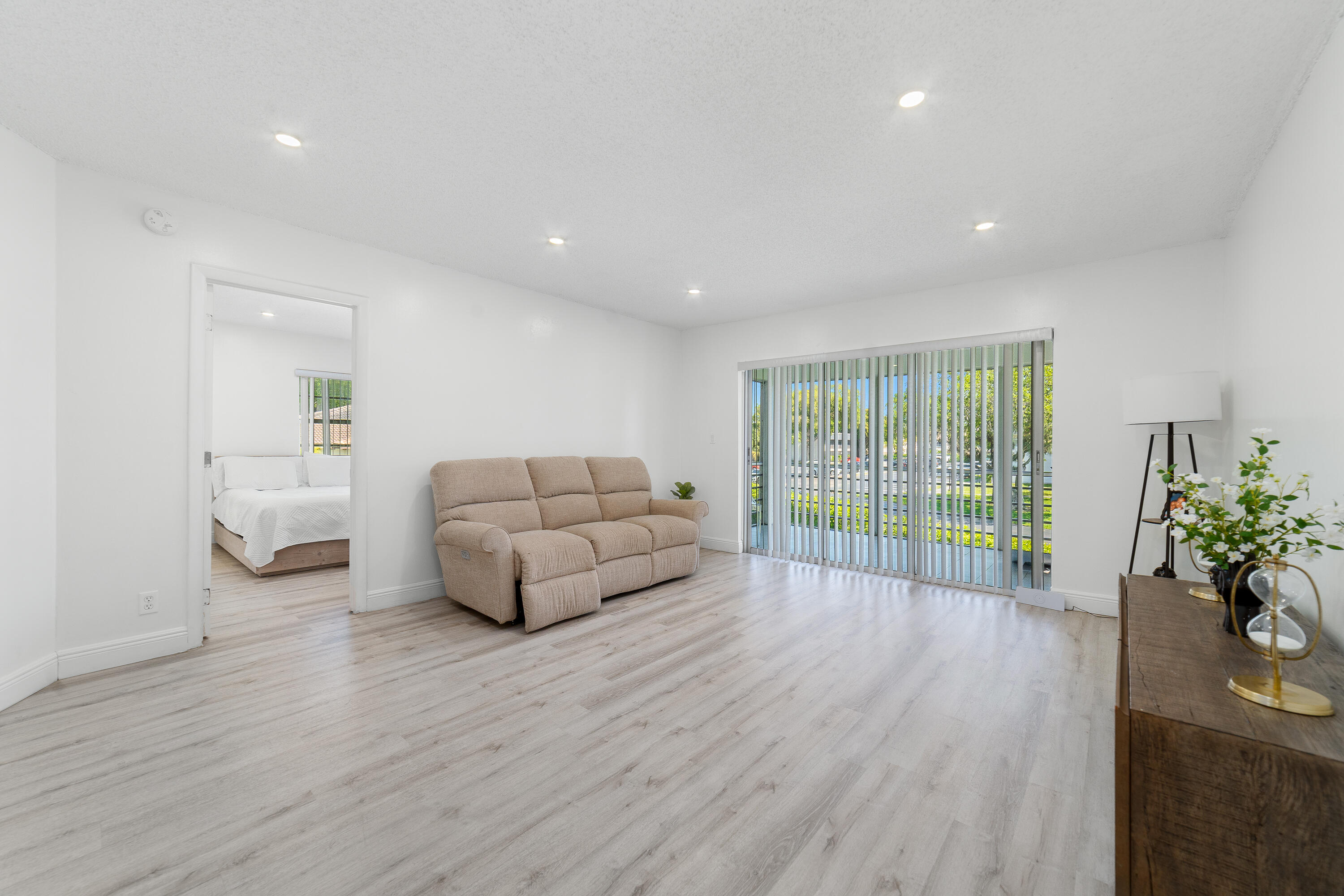 2710 Riverside Drive, Unit 201A Coral Springs, FL 33065 - Photo 4 of 23 a living room with furniture and a large window