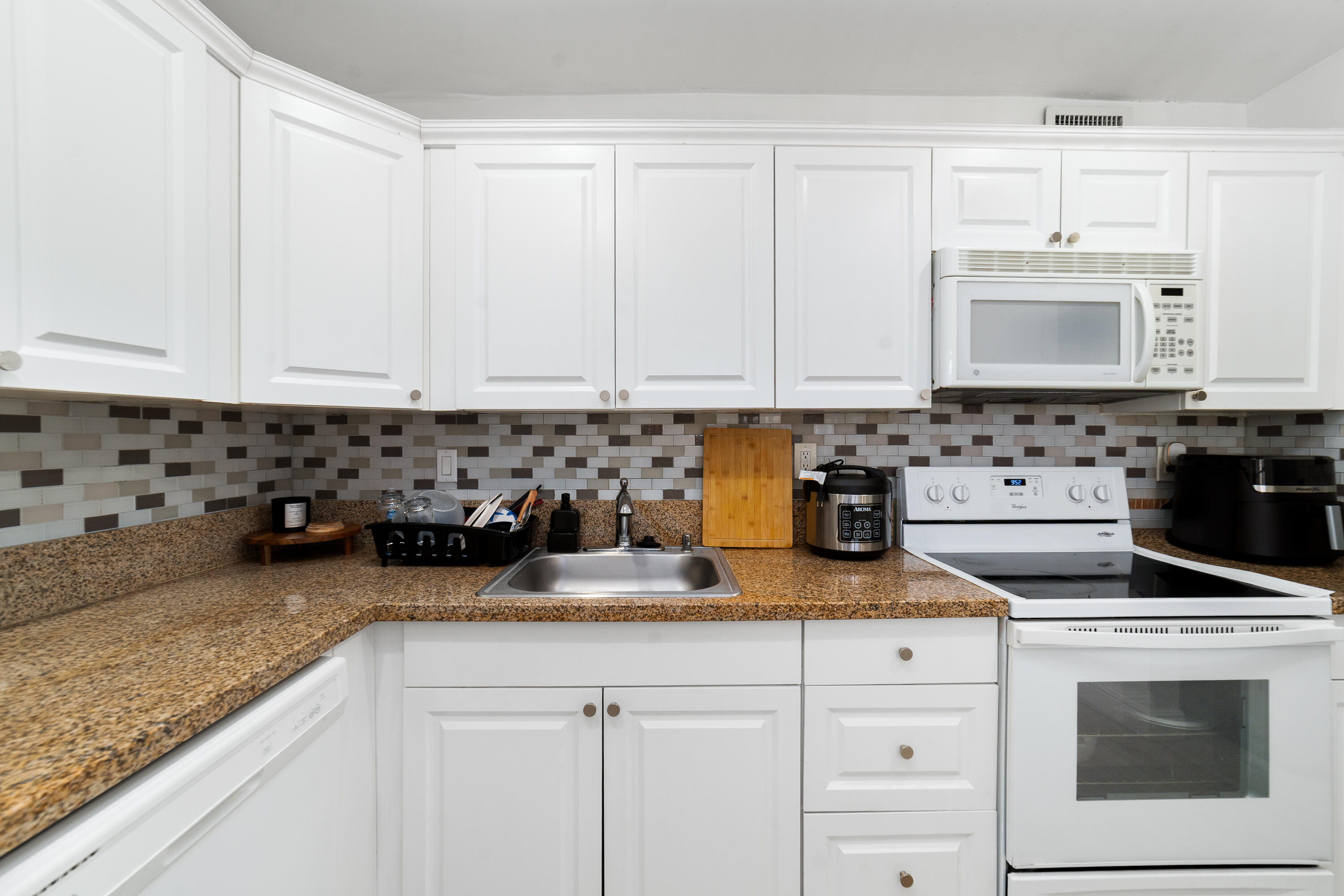2710 Riverside Drive, Unit 201A Coral Springs, FL 33065 - Photo 8 of 23 a kitchen with granite countertop white cabinets and sink