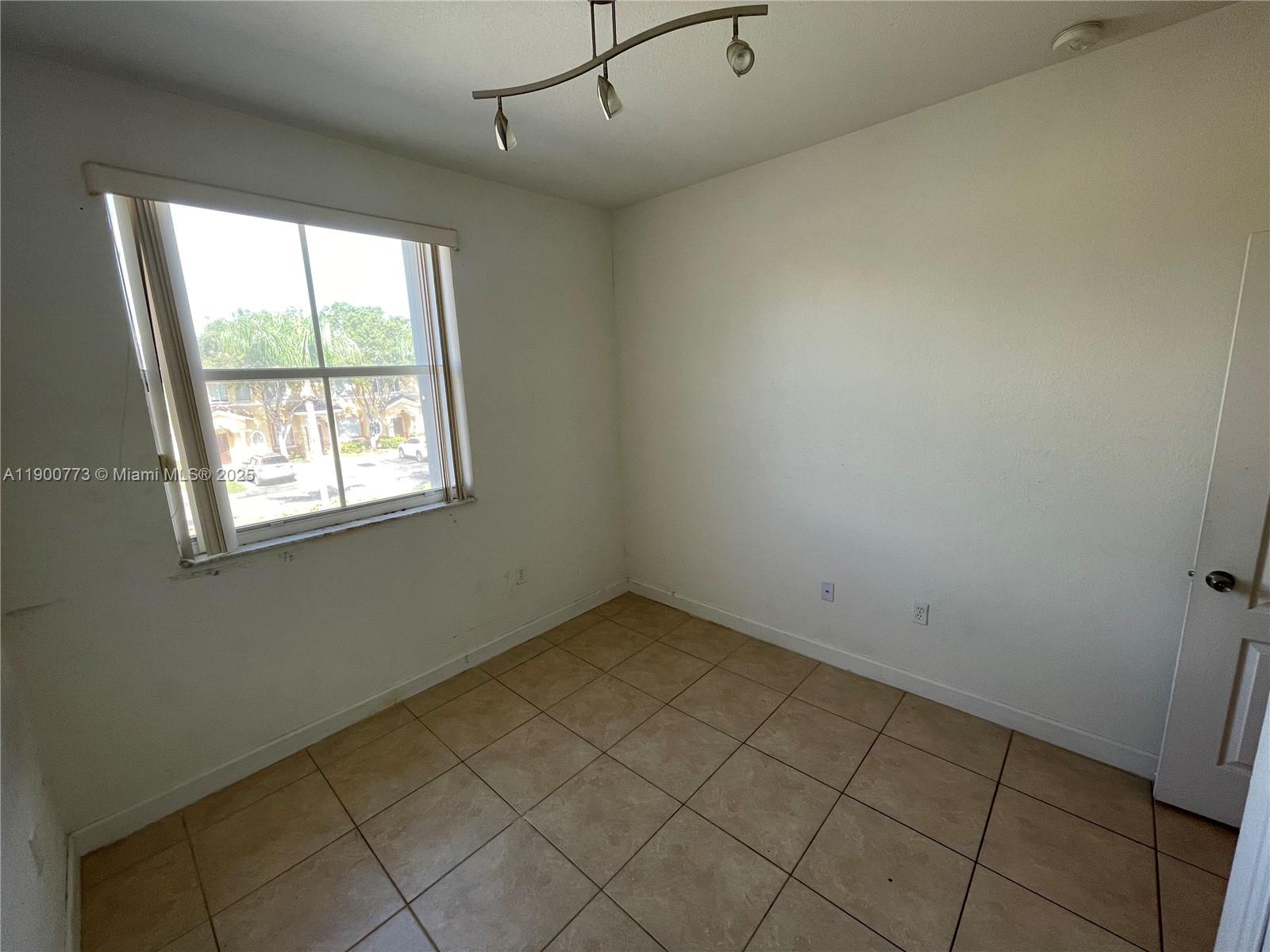 2835 Southeast 16th Avenue, Unit 201 Homestead, FL 33035 - Photo 11 of 18 an empty room with windows
