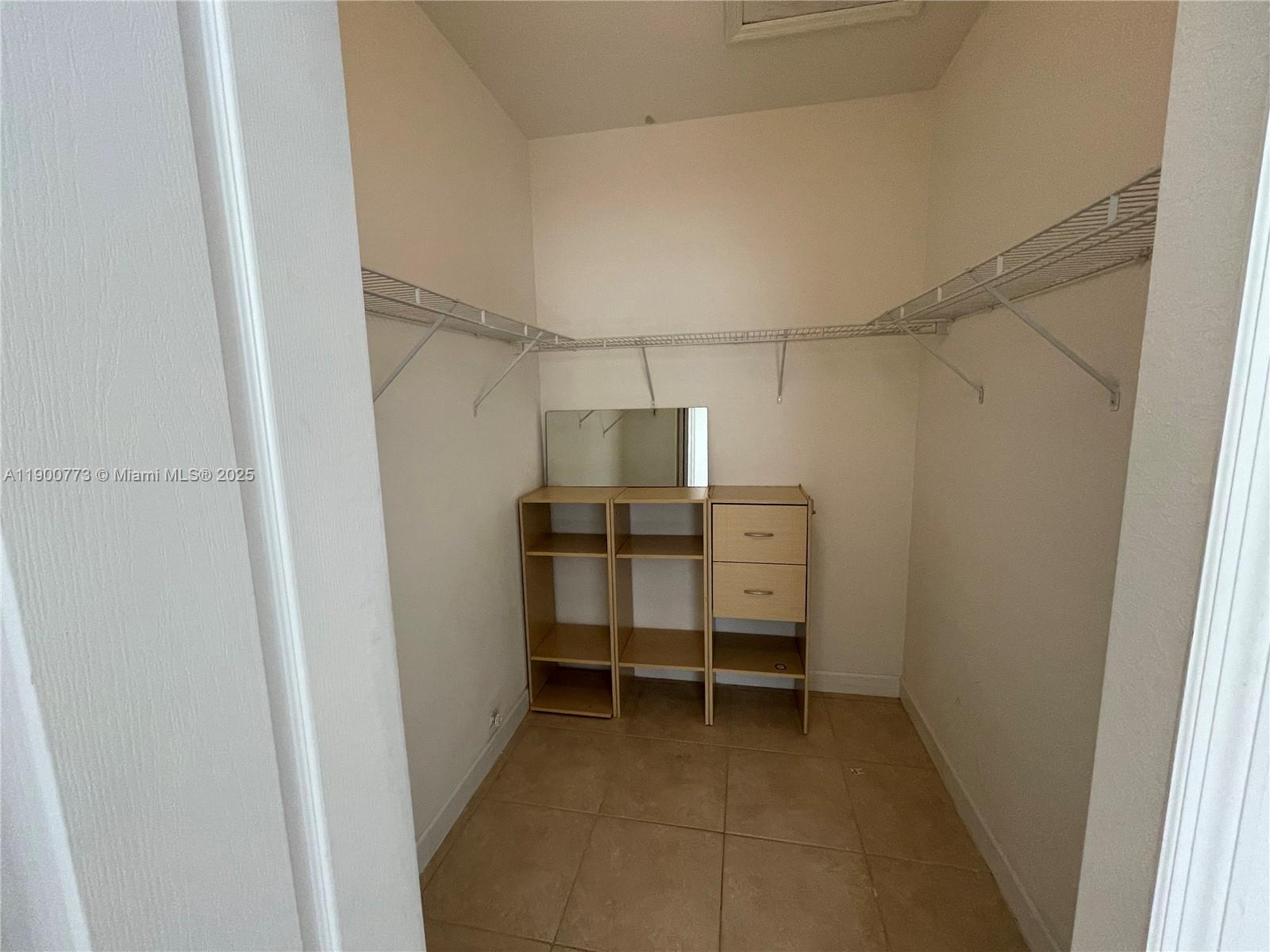 2835 Southeast 16th Avenue, Unit 201 Homestead, FL 33035 - Photo 12 of 18 a view of room with racks on the wall