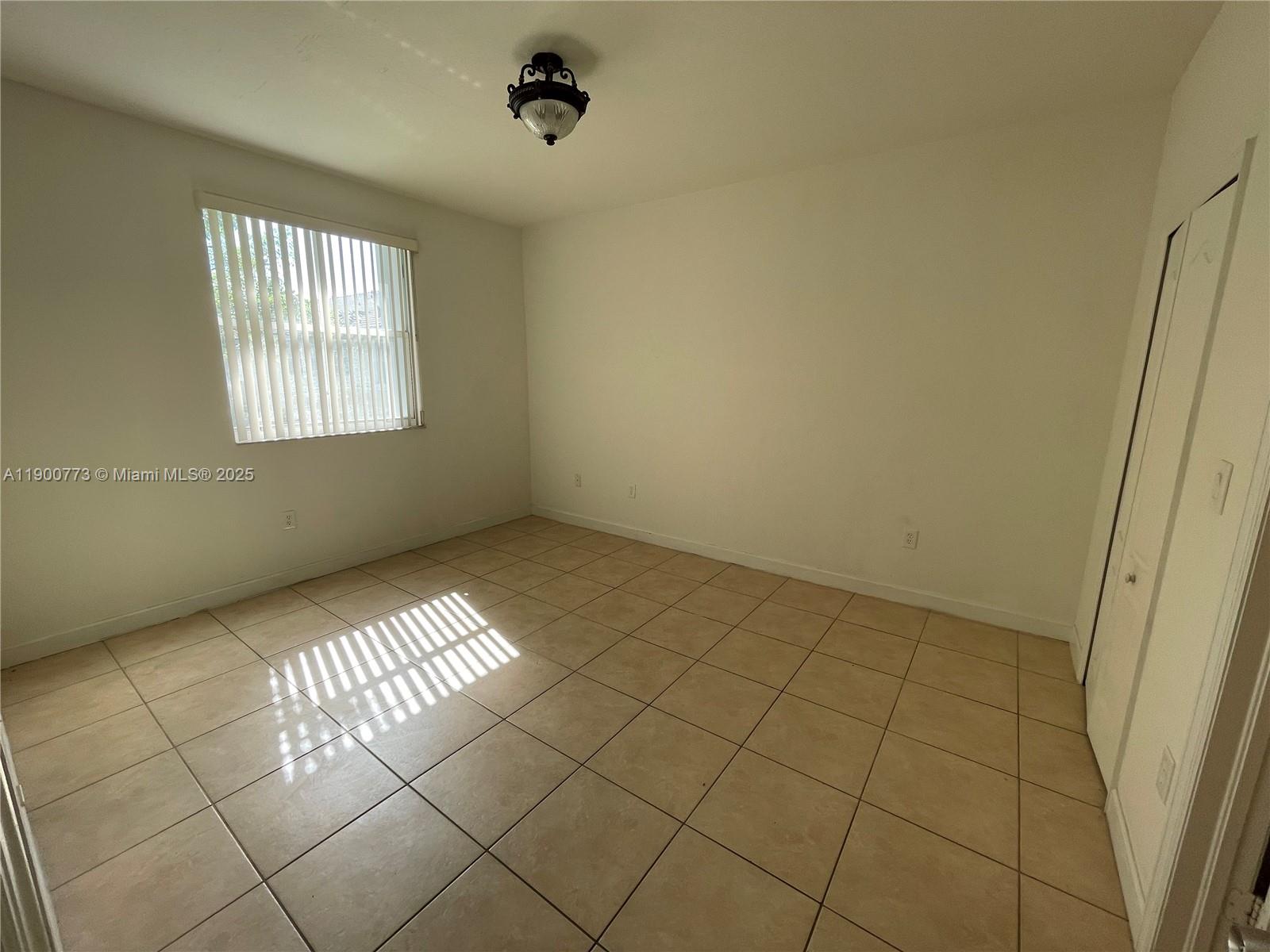 2835 Southeast 16th Avenue, Unit 201 Homestead, FL 33035 - Photo 13 of 18 a view of an empty room and a window