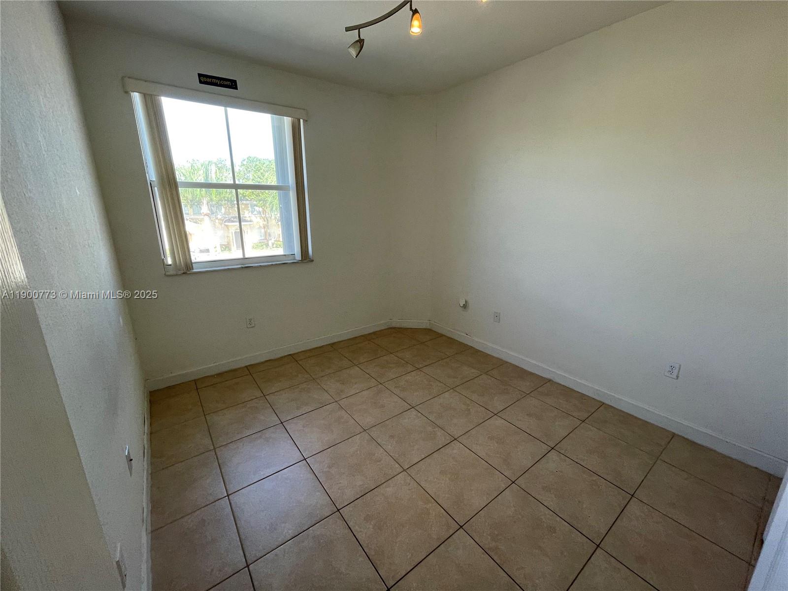 2835 Southeast 16th Avenue, Unit 201 Homestead, FL 33035 - Photo 14 of 18 an empty room with windows