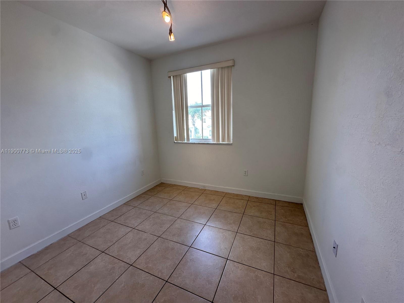 2835 Southeast 16th Avenue, Unit 201 Homestead, FL 33035 - Photo 15 of 18 an empty room with windows