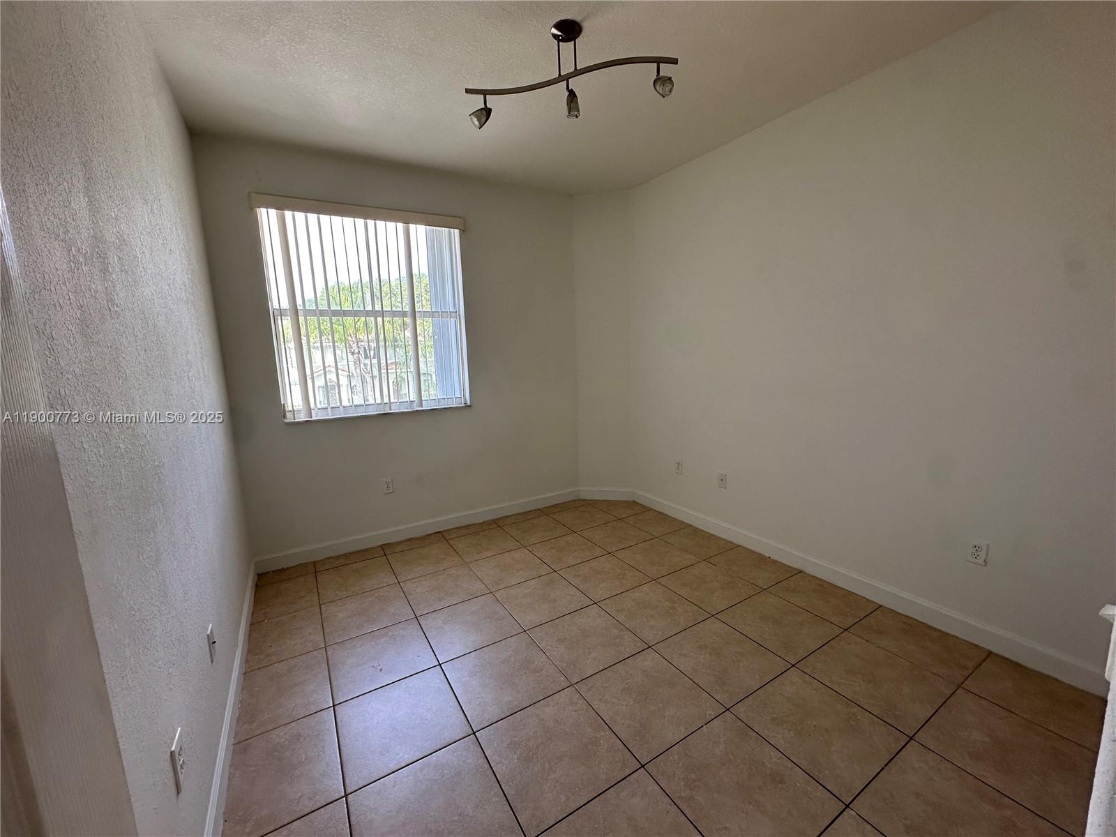 2835 Southeast 16th Avenue, Unit 201 Homestead, FL 33035 - Photo 16 of 18 a view of an empty room and window