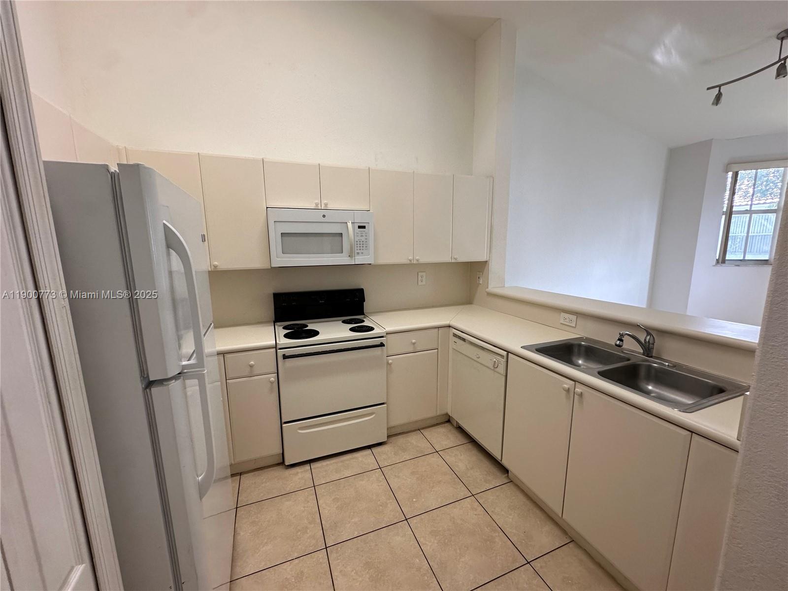 2835 Southeast 16th Avenue, Unit 201 Homestead, FL 33035 - Photo 18 of 18 a kitchen with a sink stove and refrigerator