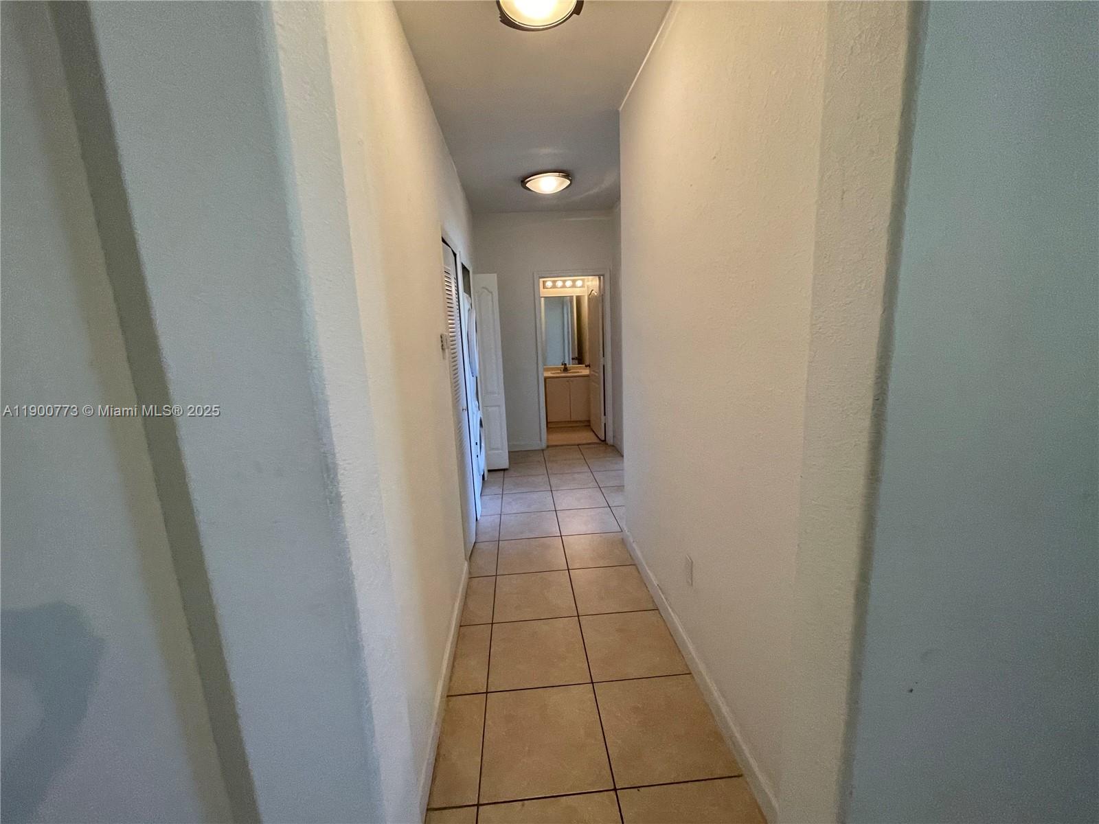 2835 Southeast 16th Avenue, Unit 201 Homestead, FL 33035 - Photo 5 of 18 a view of hallway with a bathroom and a sink