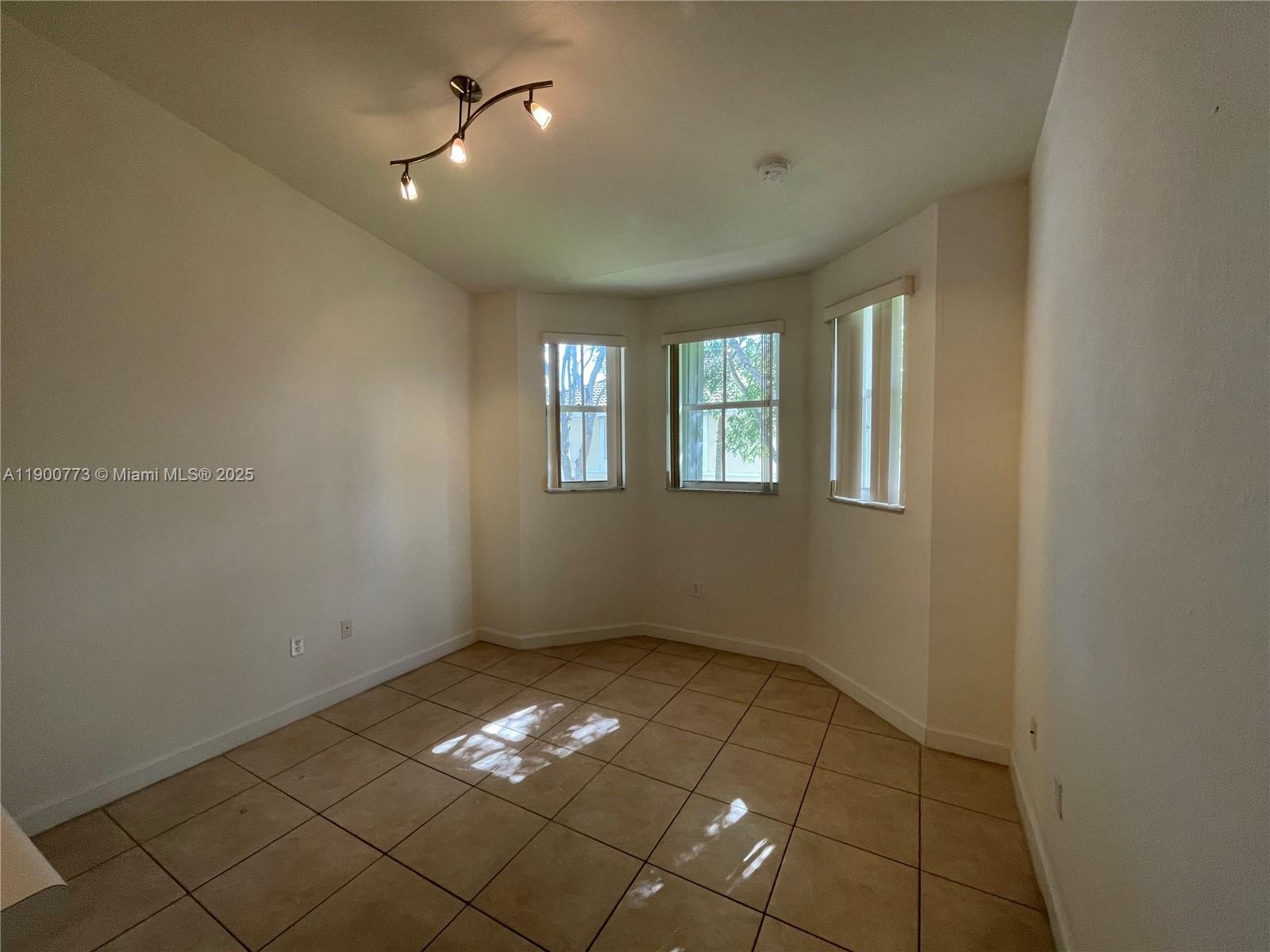 2835 Southeast 16th Avenue, Unit 201 Homestead, FL 33035 - Photo 6 of 18 a view of an empty room with a window