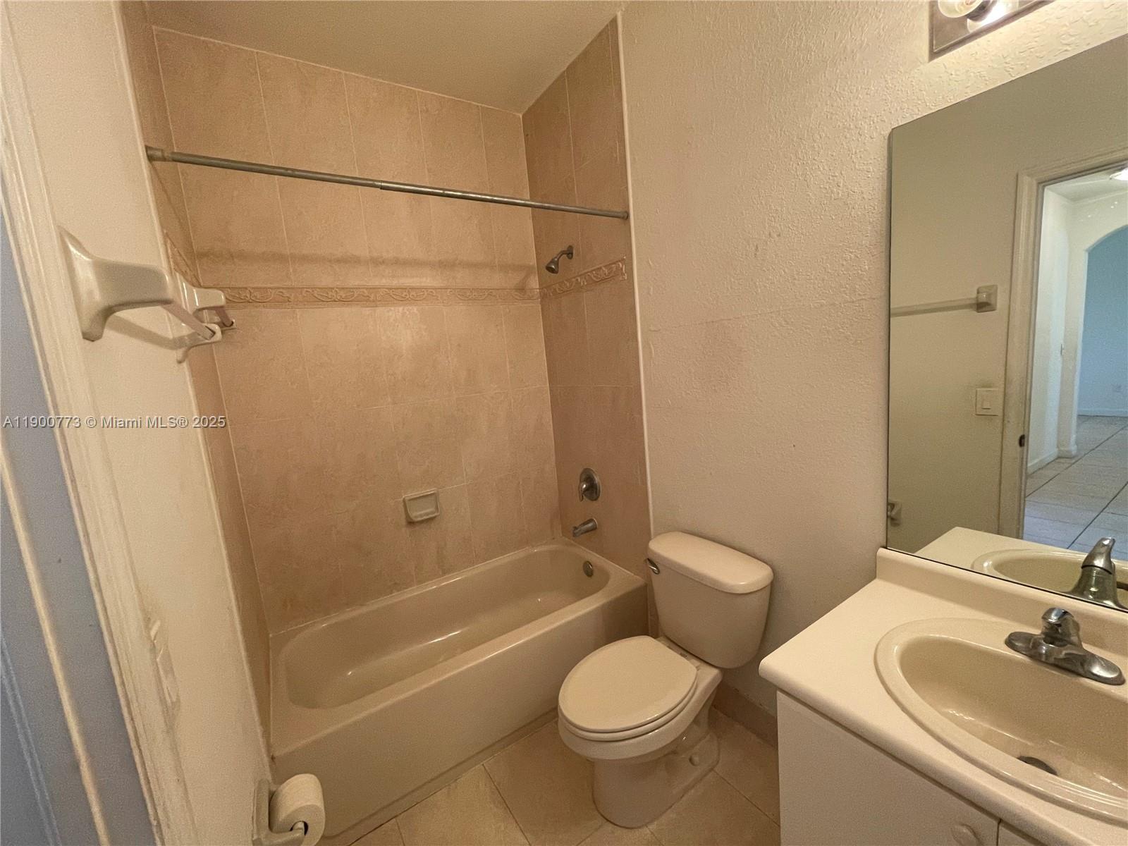 2835 Southeast 16th Avenue, Unit 201 Homestead, FL 33035 - Photo 10 of 18 a bathroom with a granite countertop sink toilet and shower