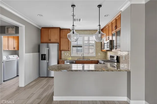 a kitchen with kitchen island a counter top space a sink and a window