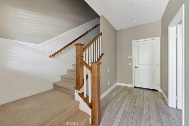 a view of hallway with stairs and wooden floor