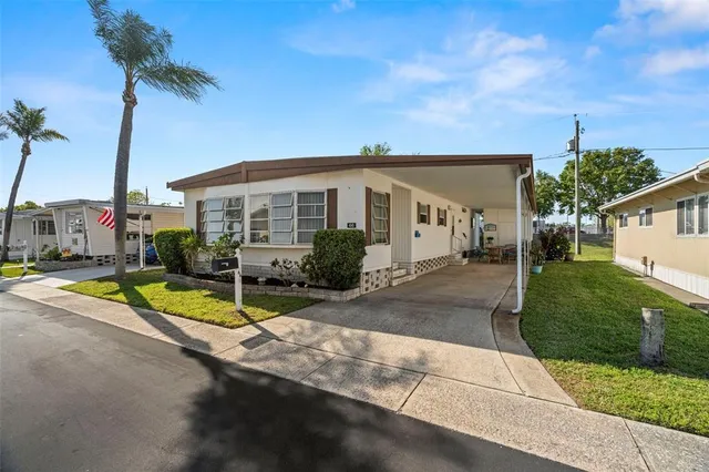 a view of a house with backyard and swimming pool
