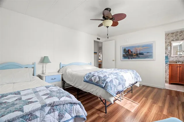 a bedroom with bed and a chandelier