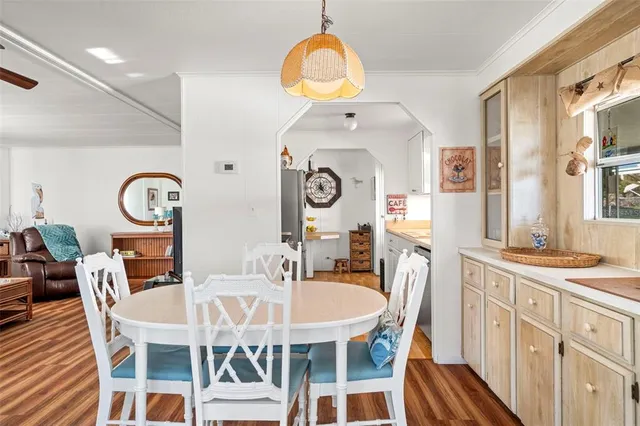 a view of a dining room with furniture and a chandelier