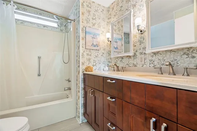 a bathroom with a tub sink shower and mirror