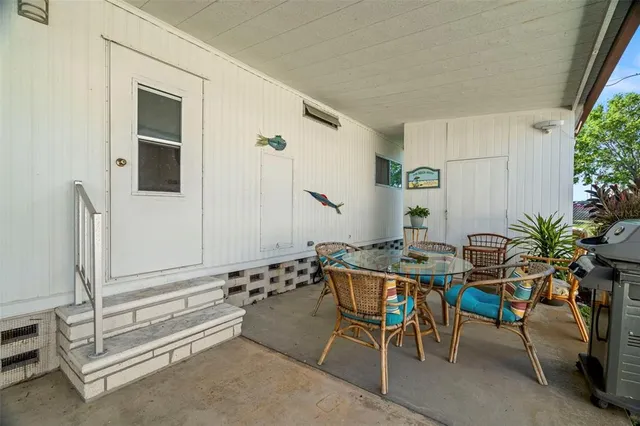 a backyard with table and chairs
