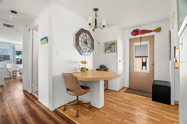 a living room with table and a wooden floor
