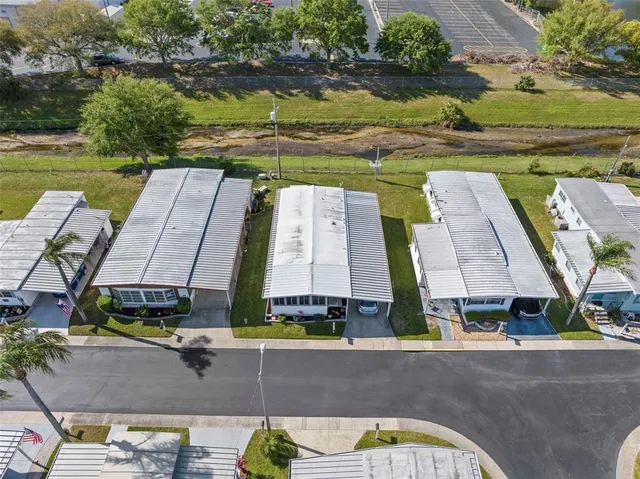 an aerial view of a house with a garden and lake view