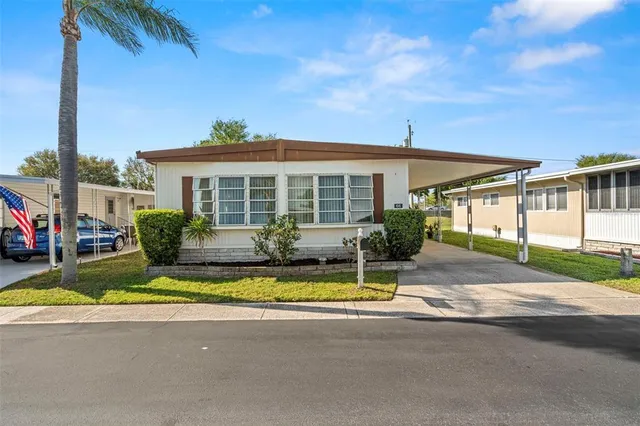 a view of house with outdoor space and swimming pool