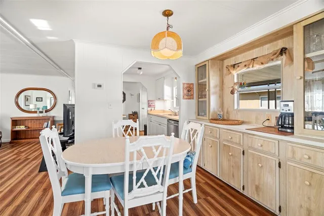 a view of a dining room with furniture and a chandelier