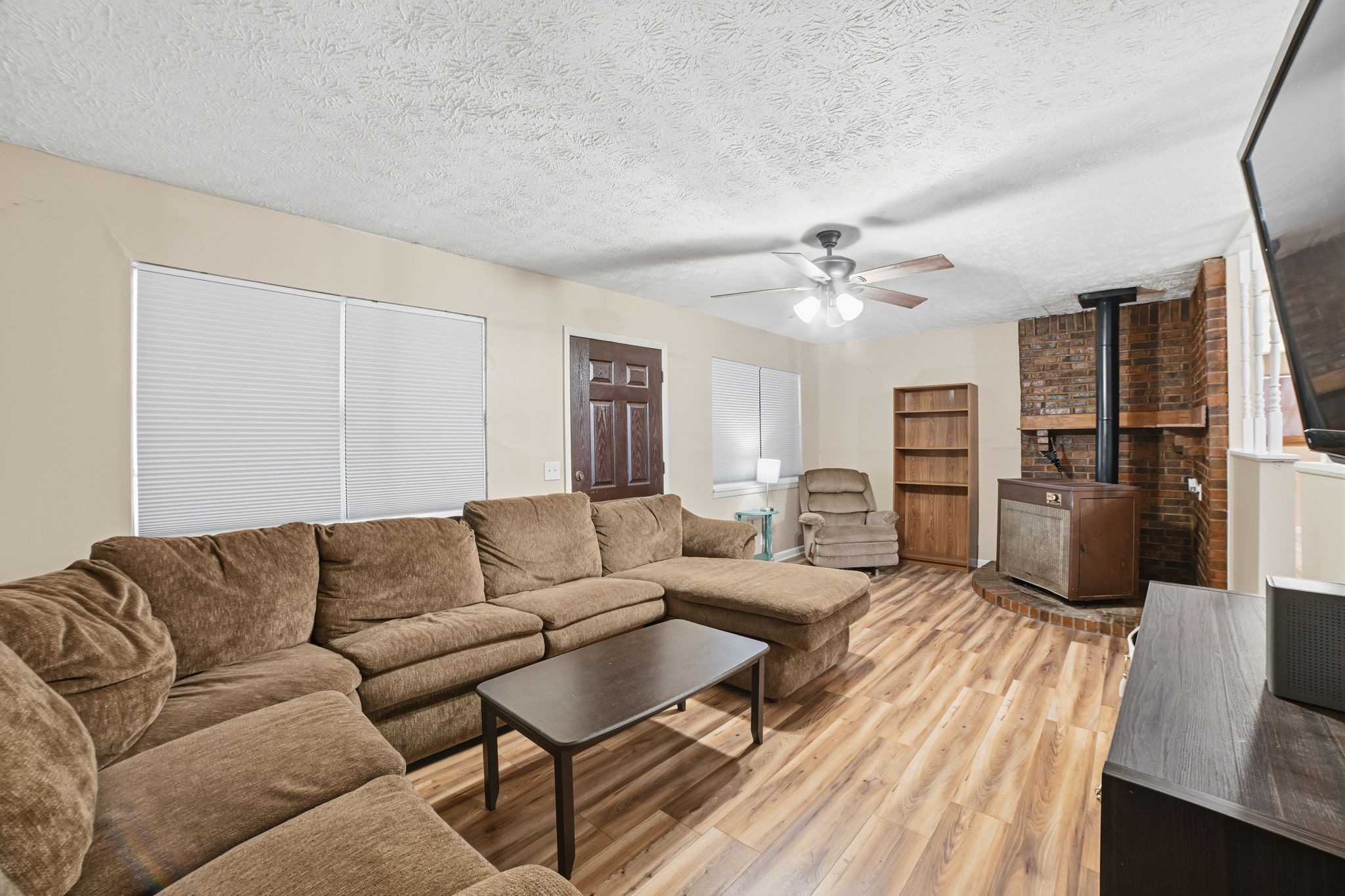 428 Scarborough Hollow Road Stewart, TN 37175 - Photo 12 of 28 a living room with furniture ceiling fan and a wooden floor