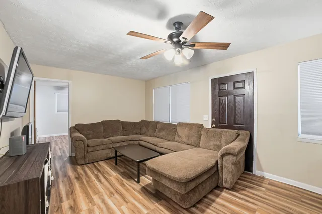 a living room with furniture and a flat screen tv
