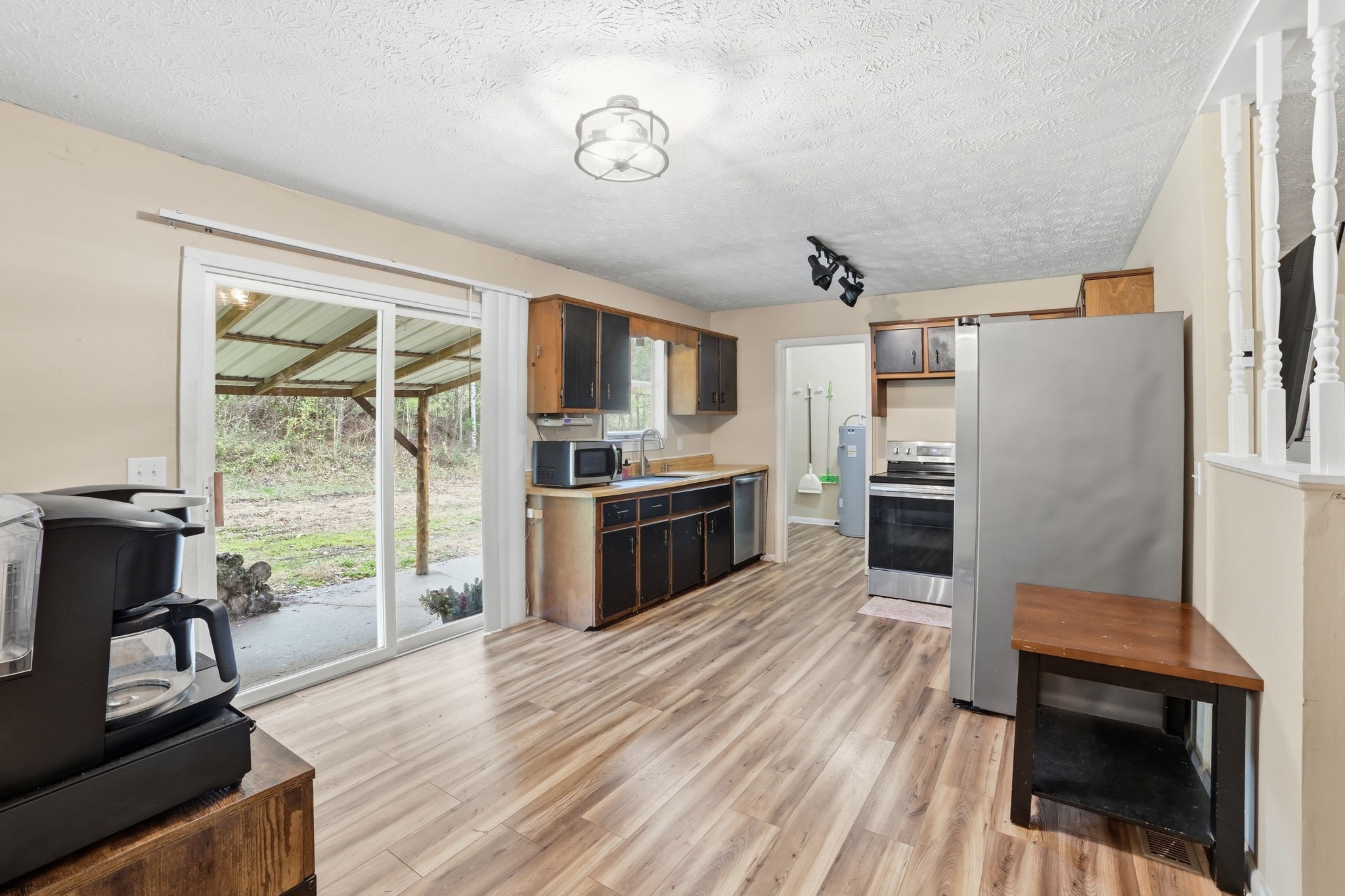 428 Scarborough Hollow Road Stewart, TN 37175 - Photo 14 of 28 a kitchen with granite countertop a refrigerator a stove a sink and a dining table with wooden floor