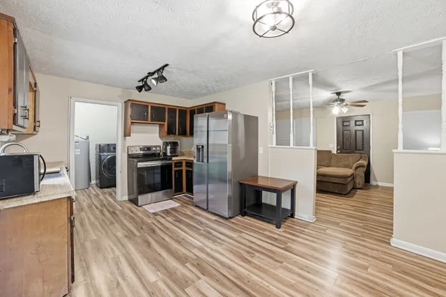a kitchen with stainless steel appliances a refrigerator and a stove