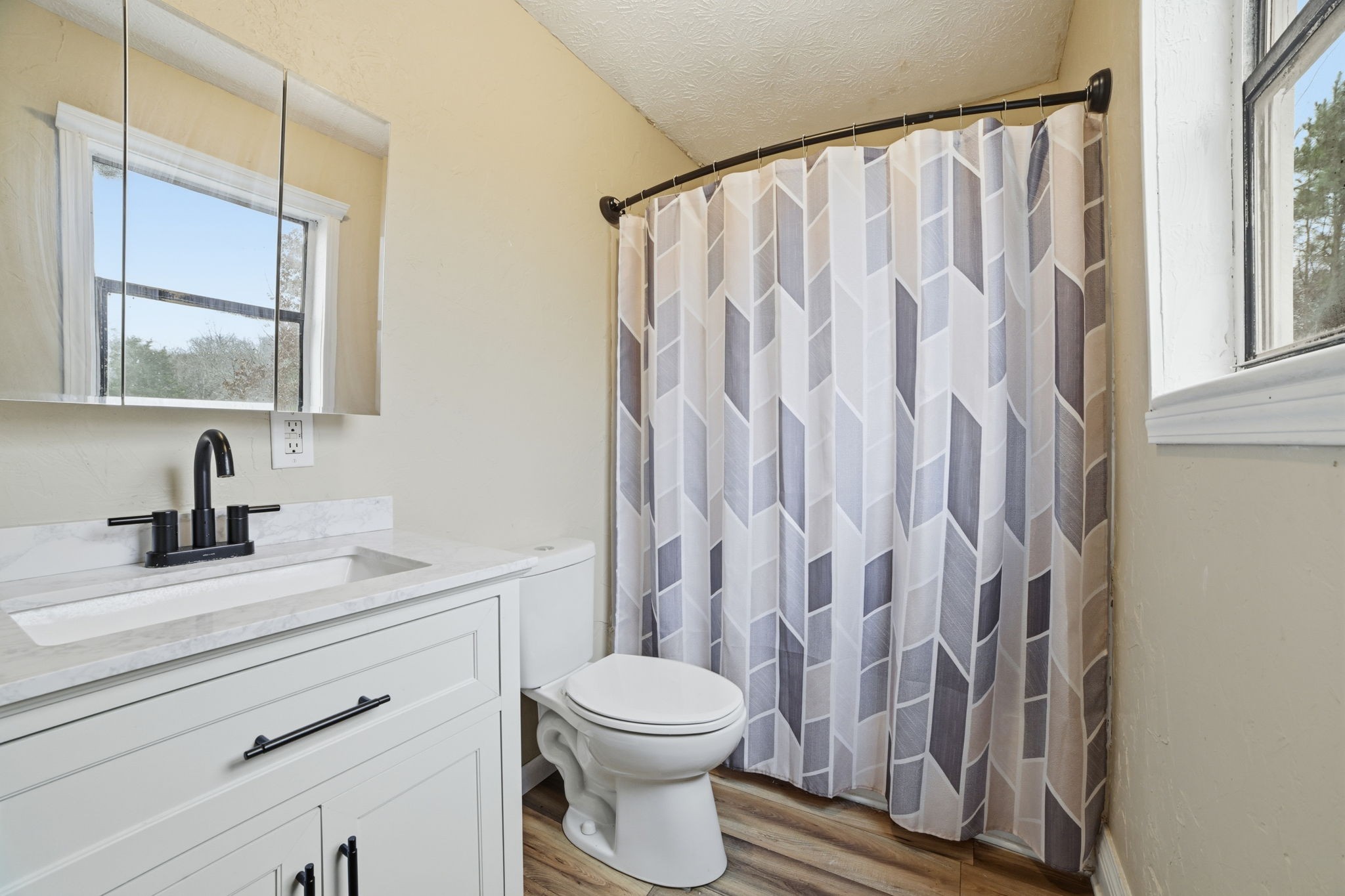 428 Scarborough Hollow Road Stewart, TN 37175 - Photo 18 of 28 a bathroom with a granite countertop sink a toilet and a mirror
