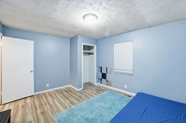 a bedroom with a bed and a mirror