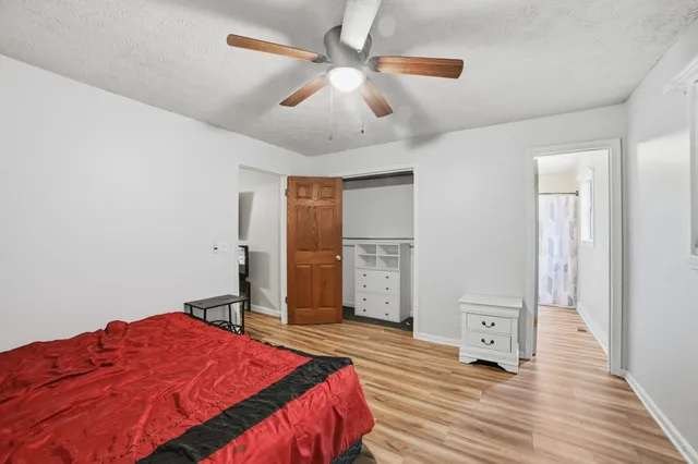 a bedroom with a bed and a chandelier