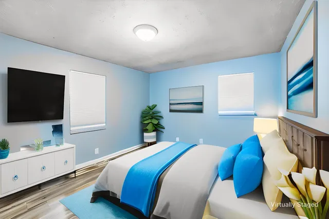 a bedroom with a bed and a flat screen tv